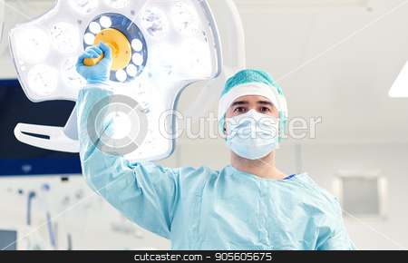 To use this stock image in your creative project, please select the size you need over to the right and click the "Add to Cart" button.
Your downloaded image will come with the Cutcaster watermark removed so don’t worry about the watermark you see on this page. surgeon in operating room at hospital stock photo, surgery, medicine and people concept - surgeon in mask adjusting lamp in operating room at hospital by Syda Productions