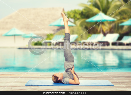 To use this stock image in your creative project, please select the size you need over to the right and click the "Add to Cart" button.
Your downloaded image will come with the Cutcaster watermark removed so don’t worry about the watermark you see on this page. woman making yoga in shoulderstand pose on mat stock photo, fitness, sport, people and healthy lifestyle concept - woman making yoga in shoulderstand pose on mat over beach and swimming pool background by Syda Productions