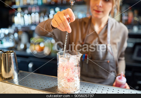 To use this stock image in your creative project, please select the size you need over to the right and click the "Add to Cart" button.
Your downloaded image will come with the Cutcaster watermark removed so don’t worry about the watermark you see on this page. bartender with cocktail stirrer and glass at bar stock photo, alcohol drinks, people and luxury concept - woman bartender with stirrer and glass of ice preparing cocktail at bar counter by Syda Productions