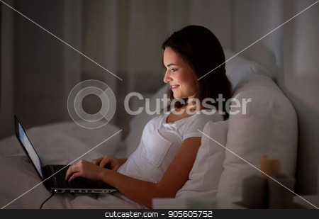 To use this stock image in your creative project, please select the size you need over to the right and click the "Add to Cart" button.
Your downloaded image will come with the Cutcaster watermark removed so don’t worry about the watermark you see on this page. happy woman with laptop in bed at home bedroom stock photo, technology, internet, communication and people concept - happy smiling young woman with laptop computer in bed at home bedroom at night by Syda Productions