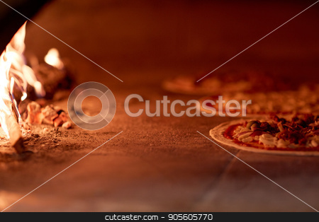 To use this stock image in your creative project, please select the size you need over to the right and click the "Add to Cart" button.
Your downloaded image will come with the Cutcaster watermark removed so don’t worry about the watermark you see on this page. pizza baking in oven at pizzeria stock photo, food, italian kitchen and cooking concept - pizza baking in oven at pizzeria by Syda Productions