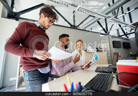 To use this stock image in your creative project, please select the size you need over to the right and click the "Add to Cart" button.
Your downloaded image will come with the Cutcaster watermark removed so don’t worry about the watermark you see on this page. business team with tablet pc and papers in office stock photo, business, technology and people concept - international creative team with papers and tablet pc computer and papers in office by Syda Productions