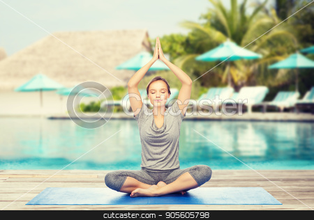 To use this stock image in your creative project, please select the size you need over to the right and click the "Add to Cart" button.
Your downloaded image will come with the Cutcaster watermark removed so don’t worry about the watermark you see on this page. woman making yoga meditation in lotus pose on mat stock photo, fitness, sport, people and healthy lifestyle concept - woman making yoga meditation in lotus pose on mat over beach and swimming pool background by Syda Productions