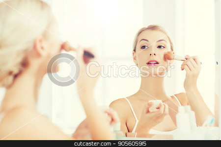 To use this stock image in your creative project, please select the size you need over to the right and click the "Add to Cart" button.
Your downloaded image will come with the Cutcaster watermark removed so don’t worry about the watermark you see on this page. woman with makeup brush and powder at bathroom stock photo, beauty, make up, cosmetics, morning and people concept - smiling young woman makeup brush and powder foundation looking to mirror at home bathroom by Syda Productions
