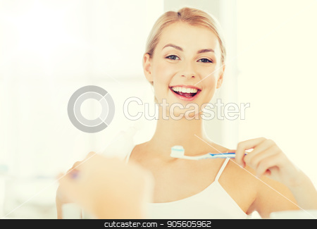 To use this stock image in your creative project, please select the size you need over to the right and click the "Add to Cart" button.
Your downloaded image will come with the Cutcaster watermark removed so don’t worry about the watermark you see on this page. woman with toothbrush cleaning teeth at bathroom stock photo, health care, dental hygiene, people and beauty concept - smiling young woman with toothbrush cleaning teeth and looking to mirror at home bathroom by Syda Productions