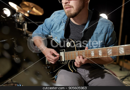 To use this stock image in your creative project, please select the size you need over to the right and click the "Add to Cart" button.
Your downloaded image will come with the Cutcaster watermark removed so don’t worry about the watermark you see on this page. man playing guitar at studio rehearsal stock photo, music, people, musical instruments and entertainment concept - male guitarist playing electric guitar at studio rehearsal by Syda Productions