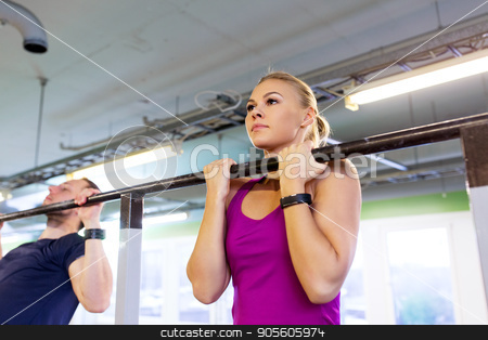 To use this stock image in your creative project, please select the size you need over to the right and click the "Add to Cart" button.
Your downloaded image will come with the Cutcaster watermark removed so don’t worry about the watermark you see on this page. couple doing pull-ups at horizontal bar in gym stock photo, sport, fitness and training concept - man and woman doing pull-ups at horizontal bar in gym by Syda Productions