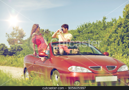 To use this stock image in your creative project, please select the size you need over to the right and click the "Add to Cart" button.
Your downloaded image will come with the Cutcaster watermark removed so don’t worry about the watermark you see on this page. happy friends with camera driving in cabriolet car stock photo, leisure, road trip, travel, summer holidays and people concept - happy friends driving in cabriolet car and taking picture by film camera by Syda Productions