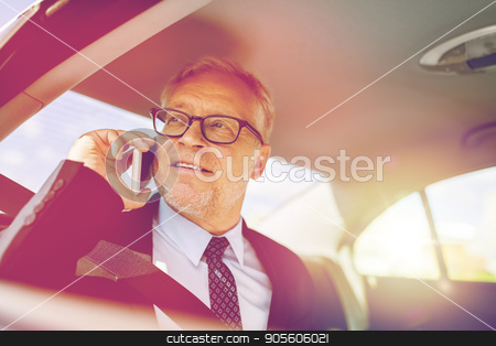 To use this stock image in your creative project, please select the size you need over to the right and click the "Add to Cart" button.
Your downloaded image will come with the Cutcaster watermark removed so don’t worry about the watermark you see on this page. senior businessman calling on smartphone in car stock photo, transport, business trip, technology and people concept - senior businessman calling on smartphone and driving on car back seat by Syda Productions