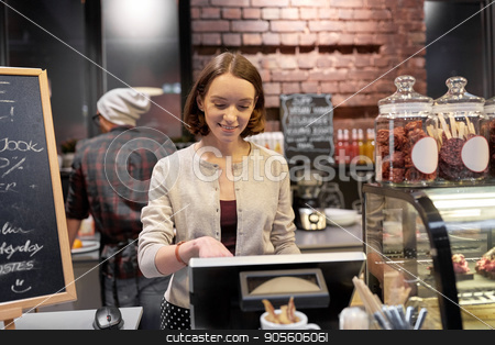 To use this stock image in your creative project, please select the size you need over to the right and click the "Add to Cart" button.
Your downloaded image will come with the Cutcaster watermark removed so don’t worry about the watermark you see on this page. happy woman or barmaid with cashbox at cafe stock photo, small business, people and service concept - happy woman or barmaid at counter with cashbox working in cafe or coffee shop by Syda Productions