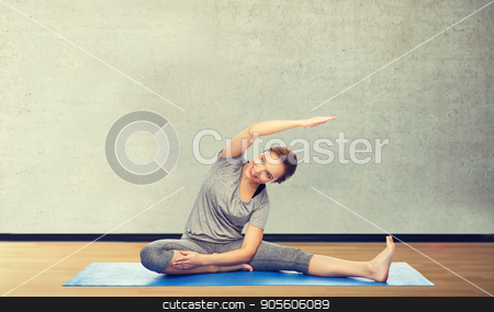 To use this stock image in your creative project, please select the size you need over to the right and click the "Add to Cart" button.
Your downloaded image will come with the Cutcaster watermark removed so don’t worry about the watermark you see on this page. happy woman making yoga and stretching on mat stock photo, fitness, sport, people and healthy lifestyle concept - happy woman making yoga and stretching on mat over gym room background by Syda Productions