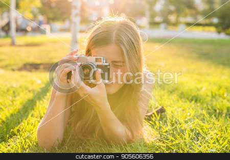 To use this stock image in your creative project, please select the size you need over to the right and click the "Add to Cart" button.
Your downloaded image will come with the Cutcaster watermark removed so don’t worry about the watermark you see on this page. Beautiful girl photographer holds a camera and lying on the grass in the spring outdoors in the park. The concept of tourism and travel stock photo, Beautiful girl-photographer holds a camera and lying on the grass in the spring outdoors in the park. The concept of tourism and travel by Satura86