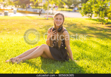 To use this stock image in your creative project, please select the size you need over to the right and click the "Add to Cart" button.
Your downloaded image will come with the Cutcaster watermark removed so don’t worry about the watermark you see on this page. beautiful young woman listening music in the park stock photo, beautiful young woman listening music in the park by Satura86
