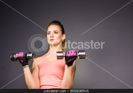 To use this stock image in your creative project, please select the size you need over to the right and click the "Add to Cart" button.
Your downloaded image will come with the Cutcaster watermark removed so don’t worry about the watermark you see on this page. Athletic woman doing exercises with dumbbells in the gym stock photo, Athletic woman doing exercises with dumbbells in the gym by Satura86