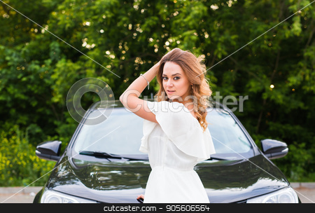 To use this stock image in your creative project, please select the size you need over to the right and click the "Add to Cart" button.
Your downloaded image will come with the Cutcaster watermark removed so don’t worry about the watermark you see on this page. A young woman in a white dress with a black car outdoor stock photo, A young woman in a white dress with a black car outdoor by Satura86