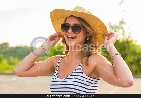 To use this stock image in your creative project, please select the size you need over to the right and click the "Add to Cart" button.
Your downloaded image will come with the Cutcaster watermark removed so don’t worry about the watermark you see on this page. Smiling summer woman with hat stock photo, Smiling summer woman with hat. Laughing young woman enjoying her time outside in park with sunset in background by Satura86