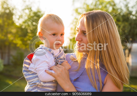 To use this stock image in your creative project, please select the size you need over to the right and click the "Add to Cart" button.
Your downloaded image will come with the Cutcaster watermark removed so don’t worry about the watermark you see on this page. Playful woman in the garden playing with her baby son stock photo, Playful woman in park playing with her laughing son by Satura86