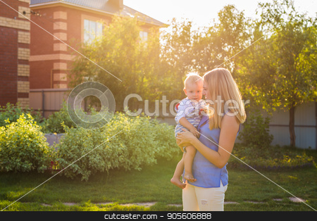To use this stock image in your creative project, please select the size you need over to the right and click the "Add to Cart" button.
Your downloaded image will come with the Cutcaster watermark removed so don’t worry about the watermark you see on this page. Happy mother holding a young son in the park stock photo, Happy mother holding a young son in the park by Satura86
