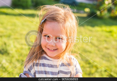To use this stock image in your creative project, please select the size you need over to the right and click the "Add to Cart" button.
Your downloaded image will come with the Cutcaster watermark removed so don’t worry about the watermark you see on this page. Portrait of sweet little girl play outdoors stock photo, Sweet little girl outdoors with curly hair in the wind by Satura86