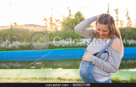 To use this stock image in your creative project, please select the size you need over to the right and click the "Add to Cart" button.
Your downloaded image will come with the Cutcaster watermark removed so don’t worry about the watermark you see on this page. Pregnant woman hugging her belly outdoors stock photo, Pregnant young woman hugging her stomach outdoors by Satura86