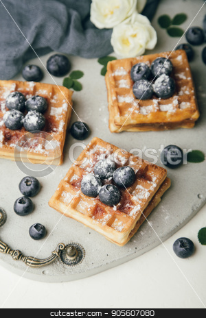 To use this stock image in your creative project, please select the size you need over to the right and click the "Add to Cart" button.
Your downloaded image will come with the Cutcaster watermark removed so don’t worry about the watermark you see on this page. Belgian waffles with fresh berries and mint stock photo, Belgian waffles with fresh blueberries and mint with white flowers on concrete tray. Delicious dessert. Top view by sunapple