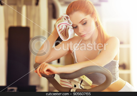 To use this stock image in your creative project, please select the size you need over to the right and click the "Add to Cart" button.
Your downloaded image will come with the Cutcaster watermark removed so don’t worry about the watermark you see on this page. Yung woman training in gym stock photo, Portrait of a sporty young woman training in gym by Ruslan Huzau