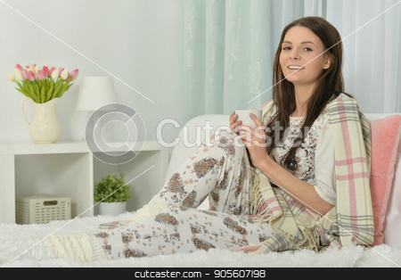 To use this stock image in your creative project, please select the size you need over to the right and click the "Add to Cart" button.
Your downloaded image will come with the Cutcaster watermark removed so don’t worry about the watermark you see on this page. Young woman in pajamas stock photo, Young woman in pajamas on bed with fluffy plaid by Ruslan Huzau