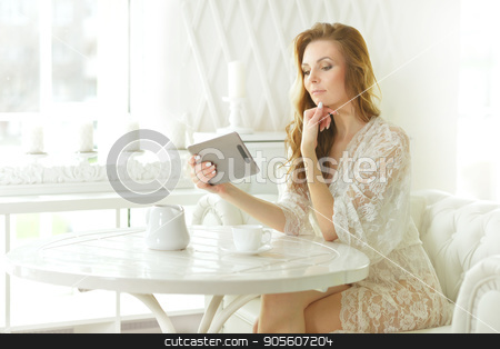 To use this stock image in your creative project, please select the size you need over to the right and click the "Add to Cart" button.
Your downloaded image will come with the Cutcaster watermark removed so don’t worry about the watermark you see on this page. Beautiful woman with tablet in hands stock photo, Beautiful young woman with tablet in hands by Ruslan Huzau