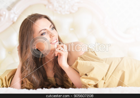 To use this stock image in your creative project, please select the size you need over to the right and click the "Add to Cart" button.
Your downloaded image will come with the Cutcaster watermark removed so don’t worry about the watermark you see on this page. Beautiful young woman in golden dress stock photo, Beautiful young woman in golden dress lying on bad by Ruslan Huzau