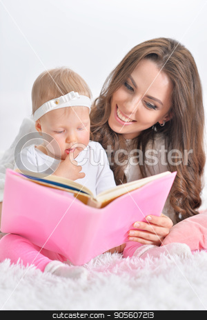 To use this stock image in your creative project, please select the size you need over to the right and click the "Add to Cart" button.
Your downloaded image will come with the Cutcaster watermark removed so don’t worry about the watermark you see on this page. Beautiful young mother with daughter reading book stock photo, Beautiful young mother with cute little daughter reading book by Ruslan Huzau