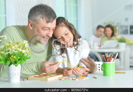 To use this stock image in your creative project, please select the size you need over to the right and click the "Add to Cart" button.
Your downloaded image will come with the Cutcaster watermark removed so don’t worry about the watermark you see on this page. Father and daughter playing together stock photo, Father and daughter sitting at table and playing together by Ruslan Huzau