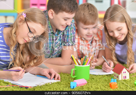 To use this stock image in your creative project, please select the size you need over to the right and click the "Add to Cart" button.
Your downloaded image will come with the Cutcaster watermark removed so don’t worry about the watermark you see on this page. Group of children drawing with pencils stock photo, Group of children lying on floor with green carpet and drawing with pencils by Ruslan Huzau