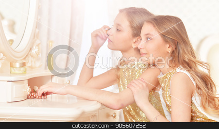 To use this stock image in your creative project, please select the size you need over to the right and click the "Add to Cart" button.
Your downloaded image will come with the Cutcaster watermark removed so don’t worry about the watermark you see on this page. cute twin sisters stock photo, Portrait of a cute twin sisters applying makeup while sitting at dressing table by Ruslan Huzau