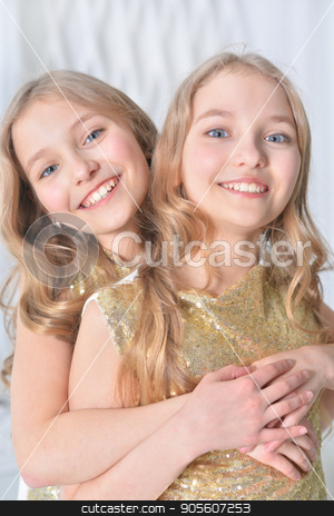 To use this stock image in your creative project, please select the size you need over to the right and click the "Add to Cart" button.
Your downloaded image will come with the Cutcaster watermark removed so don’t worry about the watermark you see on this page. Portrait of a cute twin sisters stock photo, Portrait of a cute twin sisters embrace by Ruslan Huzau