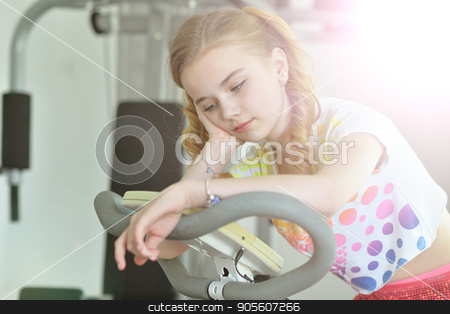 To use this stock image in your creative project, please select the size you need over to the right and click the "Add to Cart" button.
Your downloaded image will come with the Cutcaster watermark removed so don’t worry about the watermark you see on this page. Tired little girl sitting on treadmill stock photo, Tired little girl sitting on treadmill with hand on her cheek by Ruslan Huzau