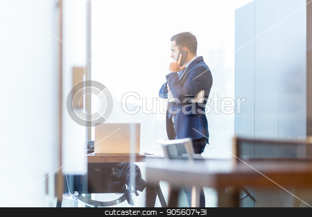 To use this stock image in your creative project, please select the size you need over to the right and click the "Add to Cart" button.
Your downloaded image will come with the Cutcaster watermark removed so don’t worry about the watermark you see on this page. Businessman talking on a mobile phone while looking through window. stock photo, Businessman talking on a mobile phone while looking through modern corporate office window, holding financial newspaper. by kasto