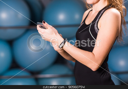 To use this stock image in your creative project, please select the size you need over to the right and click the "Add to Cart" button.
Your downloaded image will come with the Cutcaster watermark removed so don’t worry about the watermark you see on this page. Close-up of female hands with fitness tracker and smartphone in gym stock photo, Young woman with fitness tracker and smartphone in gym by Satura86