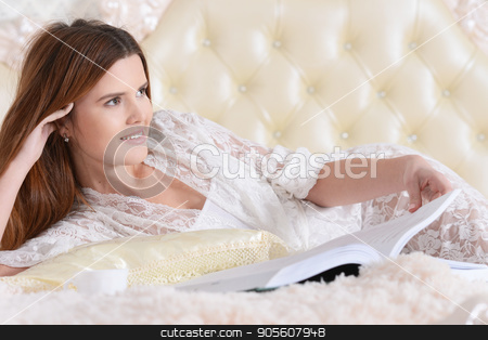 To use this stock image in your creative project, please select the size you need over to the right and click the "Add to Cart" button.
Your downloaded image will come with the Cutcaster watermark removed so don’t worry about the watermark you see on this page. Young woman lying on bed stock photo, Beautiful young woman with opened book lying on soft beige bed by Ruslan Huzau