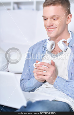 To use this stock image in your creative project, please select the size you need over to the right and click the "Add to Cart" button.
Your downloaded image will come with the Cutcaster watermark removed so don’t worry about the watermark you see on this page. Portrait of handsome young man stock photo, Portrait of handsome young man with modern laptop and cup of coffee by Ruslan Huzau