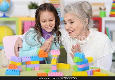 To use this stock image in your creative project, please select the size you need over to the right and click the "Add to Cart" button.
Your downloaded image will come with the Cutcaster watermark removed so don’t worry about the watermark you see on this page. Grandmother playing with granddaughter stock photo, Portrait of a grandmother playing with her little granddaughter by Ruslan Huzau