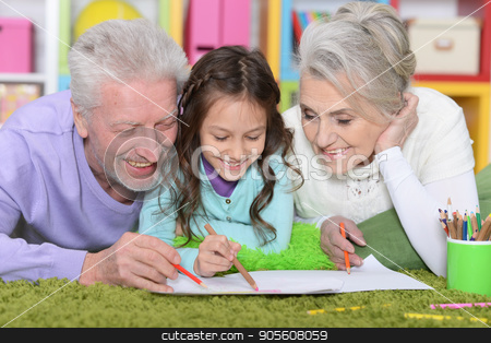 To use this stock image in your creative project, please select the size you need over to the right and click the "Add to Cart" button.
Your downloaded image will come with the Cutcaster watermark removed so don’t worry about the watermark you see on this page. Girl with grandparents drawing picture stock photo, Little girl with grandparents lying on floor and drawing picture by Ruslan Huzau