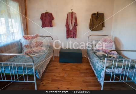 To use this stock image in your creative project, please select the size you need over to the right and click the "Add to Cart" button.
Your downloaded image will come with the Cutcaster watermark removed so don’t worry about the watermark you see on this page. Old Slavic interior stock photo, Old Slavic interior, bedroom with two beds, male and female clothes, and old box by olinchuk