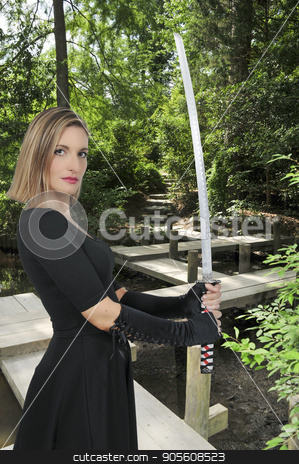 To use this stock image in your creative project, please select the size you need over to the right and click the "Add to Cart" button.
Your downloaded image will come with the Cutcaster watermark removed so don’t worry about the watermark you see on this page. Woman Samurai Swordsman stock photo, Young woman with a samurai bushido katana sword by Robert Byron