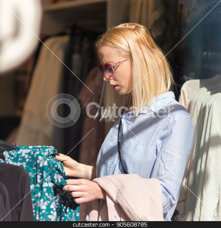 To use this stock image in your creative project, please select the size you need over to the right and click the "Add to Cart" button.
Your downloaded image will come with the Cutcaster watermark removed so don’t worry about the watermark you see on this page. Beautiful woman shopping fashionable clothes in clothing store. stock photo, Woman shopping clothes. Female shopper looking at fashionable clothes indoors in clothing store. by kasto