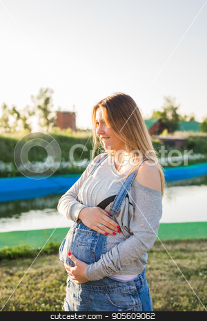 To use this stock image in your creative project, please select the size you need over to the right and click the "Add to Cart" button.
Your downloaded image will come with the Cutcaster watermark removed so don’t worry about the watermark you see on this page. Pregnant woman hugging her belly outdoors stock photo, Pregnant young woman hugging her stomach outdoors by Satura86