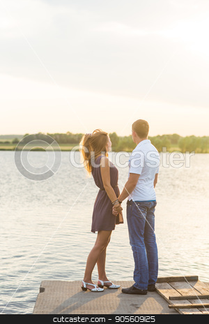 To use this stock image in your creative project, please select the size you need over to the right and click the "Add to Cart" button.
Your downloaded image will come with the Cutcaster watermark removed so don’t worry about the watermark you see on this page. Young couple in love outdoors embracing at lake rear view stock photo, Young couple in love outdoors embracing at lake rear view by Satura86