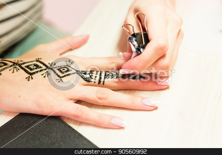 To use this stock image in your creative project, please select the size you need over to the right and click the "Add to Cart" button.
Your downloaded image will come with the Cutcaster watermark removed so don’t worry about the watermark you see on this page. young woman mehendi artist painting henna on the hand stock photo, young woman mehendi artist painting henna on the hand by Satura86