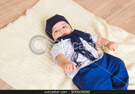 To use this stock image in your creative project, please select the size you need over to the right and click the "Add to Cart" button.
Your downloaded image will come with the Cutcaster watermark removed so don’t worry about the watermark you see on this page. Portrait of a little adorable newborn infant baby boy lying on back on blanket stock photo, Portrait of a little adorable newborn infant baby boy lying on back on blanket by Satura86