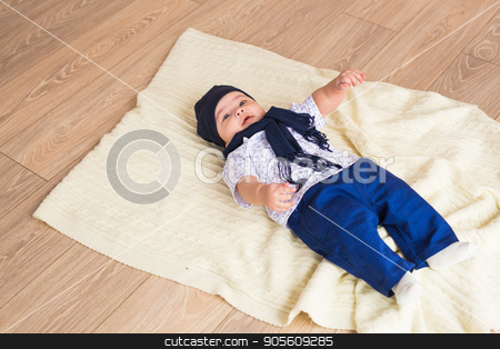 To use this stock image in your creative project, please select the size you need over to the right and click the "Add to Cart" button.
Your downloaded image will come with the Cutcaster watermark removed so don’t worry about the watermark you see on this page. Portrait of a little adorable newborn infant baby boy lying on back on blanket stock photo, Portrait of a little adorable newborn infant baby boy lying on back on blanket by Satura86