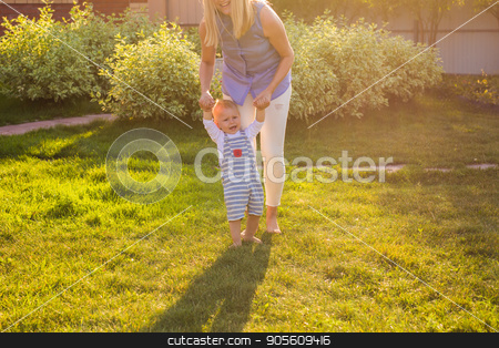 To use this stock image in your creative project, please select the size you need over to the right and click the "Add to Cart" button.
Your downloaded image will come with the Cutcaster watermark removed so don’t worry about the watermark you see on this page. First steps with mother's help stock photo, First steps with mother's help in the garden by Satura86